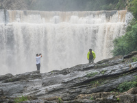 Tourists are enjoying cooling off at the Diaolan Waterfall in Xiangshui township of Bijie city, in Bijie, China, on June 23, 2024. (