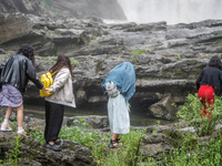 Tourists are enjoying cooling off at the Diaolan Waterfall in Xiangshui township of Bijie city, in Bijie, China, on June 23, 2024. (