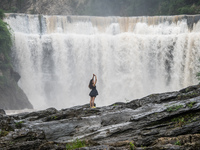 Tourists are enjoying cooling off at the Diaolan Waterfall in Xiangshui township of Bijie city, in Bijie, China, on June 23, 2024. (