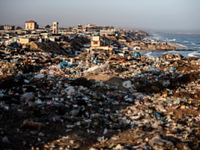 A view is showing piles of garbage next to the tents housing internally displaced Palestinians crowding the beach and the Mediterranean shor...