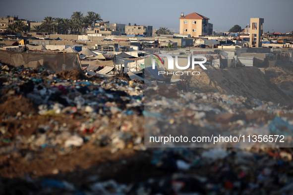 A general view is showing tents housing internally displaced Palestinians crowding the beach and the Mediterranean shoreline in Deir el-Bala...