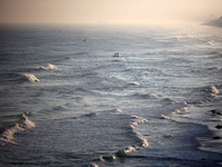 Palestinian fishermen are sailing on a boat in Deir el-Balah, central Gaza Strip, on June 24, 2024, amid the ongoing conflict between Israel...