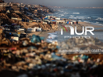 A general view is showing tents housing internally displaced Palestinians crowding the beach and the Mediterranean shoreline in Deir el-Bala...