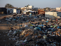 A view is showing piles of garbage next to the tents housing internally displaced Palestinians crowding the beach and the Mediterranean shor...