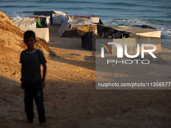 A general view is showing tents housing internally displaced Palestinians crowding the beach and the Mediterranean shoreline in Deir el-Bala...