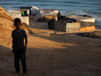 A general view is showing tents housing internally displaced Palestinians crowding the beach and the Mediterranean shoreline in Deir el-Bala...