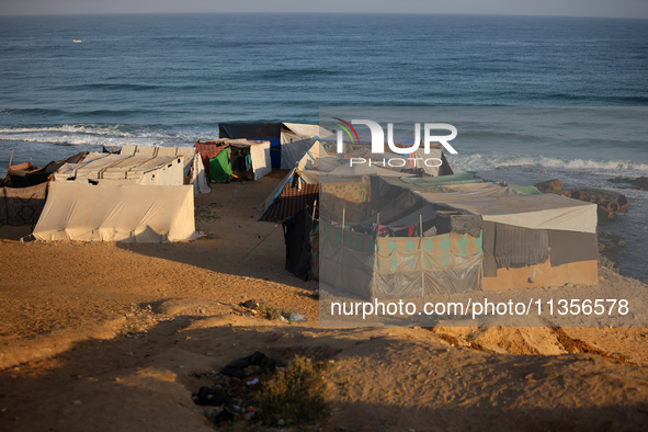 A general view is showing tents housing internally displaced Palestinians crowding the beach and the Mediterranean shoreline in Deir el-Bala...