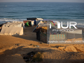 A general view is showing tents housing internally displaced Palestinians crowding the beach and the Mediterranean shoreline in Deir el-Bala...