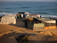 A general view is showing tents housing internally displaced Palestinians crowding the beach and the Mediterranean shoreline in Deir el-Bala...