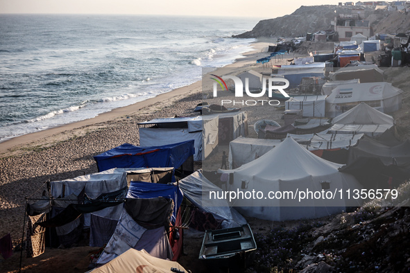 A general view is showing tents housing internally displaced Palestinians crowding the beach and the Mediterranean shoreline in Deir el-Bala...