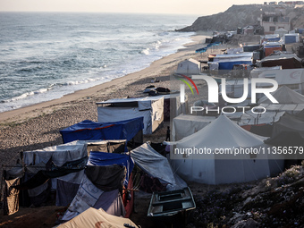 A general view is showing tents housing internally displaced Palestinians crowding the beach and the Mediterranean shoreline in Deir el-Bala...