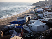 A general view is showing tents housing internally displaced Palestinians crowding the beach and the Mediterranean shoreline in Deir el-Bala...