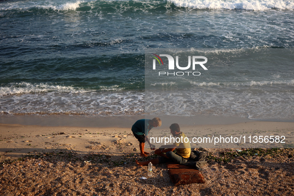 Displaced Palestinians are being seen on the beach in Deir el-Balah in the central Gaza Strip on June 24, 2024, amid the ongoing conflict be...