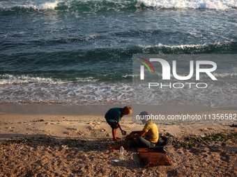 Displaced Palestinians are being seen on the beach in Deir el-Balah in the central Gaza Strip on June 24, 2024, amid the ongoing conflict be...