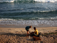 Displaced Palestinians are being seen on the beach in Deir el-Balah in the central Gaza Strip on June 24, 2024, amid the ongoing conflict be...