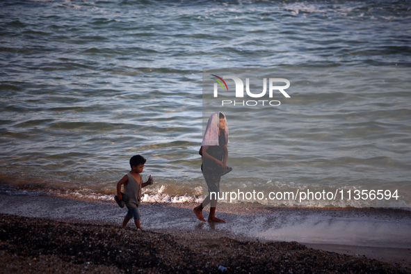 Displaced Palestinians are being seen on the beach in Deir el-Balah in the central Gaza Strip on June 24, 2024, amid the ongoing conflict be...