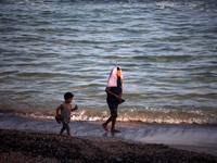 Displaced Palestinians are being seen on the beach in Deir el-Balah in the central Gaza Strip on June 24, 2024, amid the ongoing conflict be...