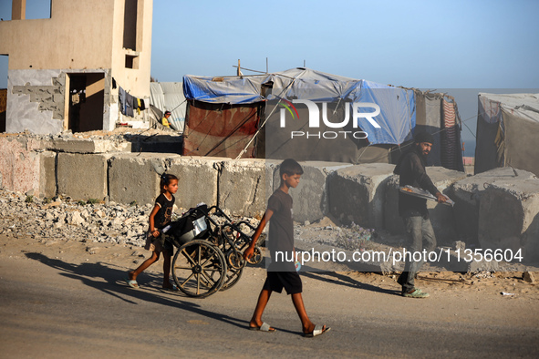 Displaced Palestinians are being seen on the beach in Deir el-Balah in the central Gaza Strip on June 24, 2024, amid the ongoing conflict be...