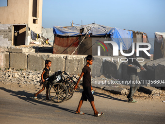 Displaced Palestinians are being seen on the beach in Deir el-Balah in the central Gaza Strip on June 24, 2024, amid the ongoing conflict be...