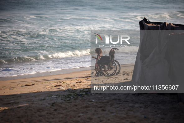 Displaced Palestinian children are being seen on the beach in Deir el-Balah in the central Gaza Strip on June 24, 2024, amid the ongoing con...