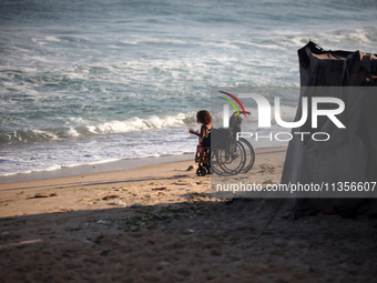 Displaced Palestinian children are being seen on the beach in Deir el-Balah in the central Gaza Strip on June 24, 2024, amid the ongoing con...