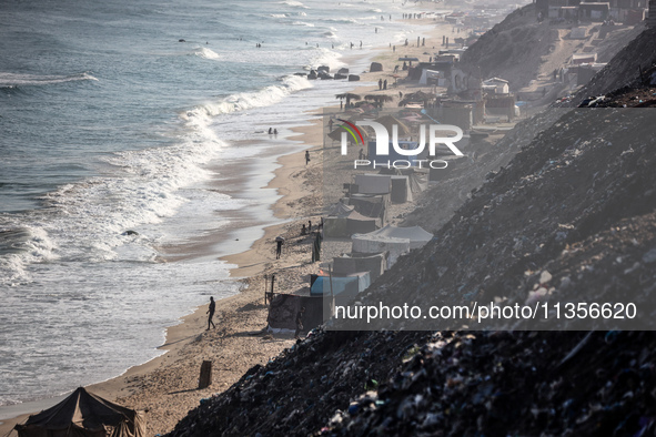 A general view is showing tents housing internally displaced Palestinians crowding the beach and the Mediterranean shoreline in Deir el-Bala...