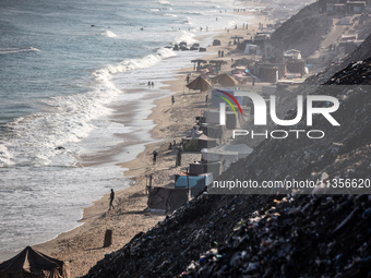 A general view is showing tents housing internally displaced Palestinians crowding the beach and the Mediterranean shoreline in Deir el-Bala...