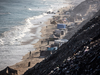 A general view is showing tents housing internally displaced Palestinians crowding the beach and the Mediterranean shoreline in Deir el-Bala...