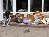 A woman is sitting by the pile of broken furniture at the Ivano-Frankivsk National Technical University of Oil and Gas damaged by a Russian...