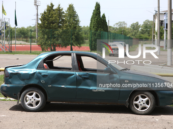 A car is being pictured at the Ivano-Frankivsk National Technical University of Oil and Gas, damaged by a Russian missile attack, in Ivano-F...