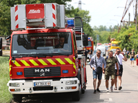 People are walking past a fire engine near the Ivano-Frankivsk National Technical University of Oil and Gas, which is damaged by a Russian m...