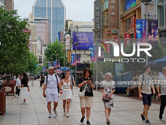 Chinese and foreign tourists are bustling along the Nanjing Road Pedestrian street in Shanghai, China, on June 24, 2024. (