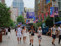 Chinese and foreign tourists are bustling along the Nanjing Road Pedestrian street in Shanghai, China, on June 24, 2024. (