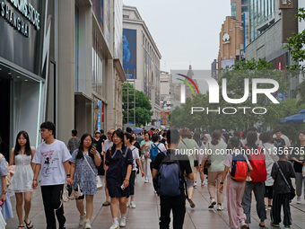 Chinese and foreign tourists are bustling along the Nanjing Road Pedestrian street in Shanghai, China, on June 24, 2024. (