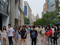 Chinese and foreign tourists are bustling along the Nanjing Road Pedestrian street in Shanghai, China, on June 24, 2024. (