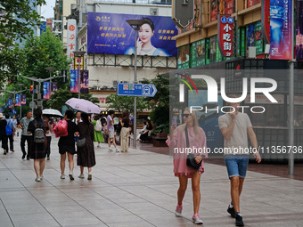 Chinese and foreign tourists are bustling along the Nanjing Road Pedestrian street in Shanghai, China, on June 24, 2024. (