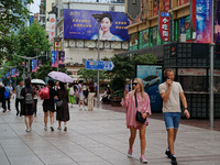 Chinese and foreign tourists are bustling along the Nanjing Road Pedestrian street in Shanghai, China, on June 24, 2024. (