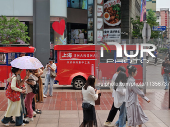 Chinese and foreign tourists are bustling along the Nanjing Road Pedestrian street in Shanghai, China, on June 24, 2024. (