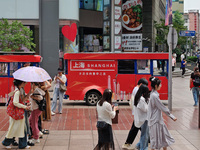 Chinese and foreign tourists are bustling along the Nanjing Road Pedestrian street in Shanghai, China, on June 24, 2024. (