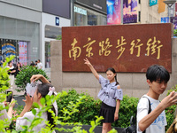 Chinese and foreign tourists are bustling along the Nanjing Road Pedestrian street in Shanghai, China, on June 24, 2024. (