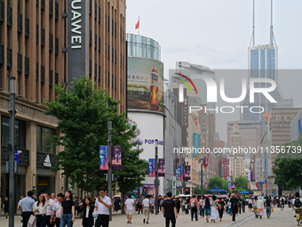 Chinese and foreign tourists are bustling along the Nanjing Road Pedestrian street in Shanghai, China, on June 24, 2024. (