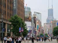 Chinese and foreign tourists are bustling along the Nanjing Road Pedestrian street in Shanghai, China, on June 24, 2024. (