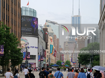 Chinese and foreign tourists are bustling along the Nanjing Road Pedestrian street in Shanghai, China, on June 24, 2024. (