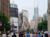 Chinese and foreign tourists are bustling along the Nanjing Road Pedestrian street in Shanghai, China, on June 24, 2024. (