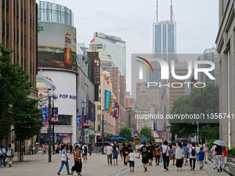 Chinese and foreign tourists are bustling along the Nanjing Road Pedestrian street in Shanghai, China, on June 24, 2024. (