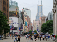 Chinese and foreign tourists are bustling along the Nanjing Road Pedestrian street in Shanghai, China, on June 24, 2024. (