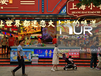 Chinese and foreign tourists are bustling along the Nanjing Road Pedestrian street in Shanghai, China, on June 24, 2024. (