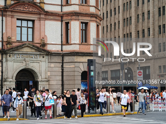 Chinese and foreign tourists are bustling along the Nanjing Road Pedestrian street in Shanghai, China, on June 24, 2024. (