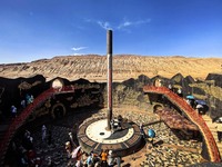 Tourists are visiting the Flaming Mountain scenic spot in Turpan, Xinjiang province, China, on June 24, 2024. A golden stick-shaped thermome...