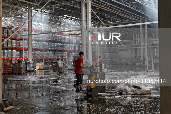 Workers are removing the debris in a warehouse damaged by a Russian missile strike in Odesa, Ukraine, on June 24, 2024. NO USE RUSSIA. NO US...